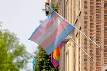 Celebration of pride month in Amsterdam, Transgender flag (Blue, Pink, White) hanging outside...