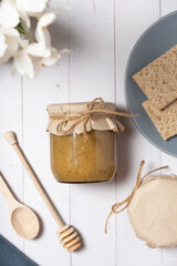 Jar with propolis honey on wooden background top view, flat lay