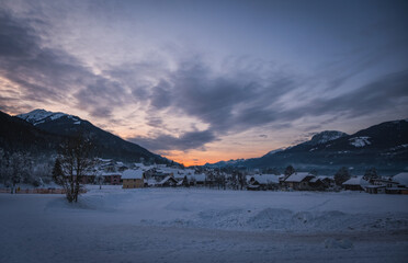Sunset over Troepolach and Rattendorf. Lower station of the ski lift on Nassfeld ski resort. Carinthia, Austria. January 2022