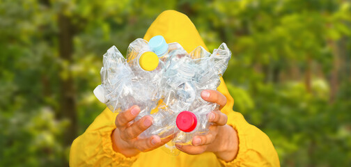 Volunteer hands holding bottle plastic garbage. Environment clean up park cleaning trash nature. Volunteer cleaning forest. PET waste plastic hand trash pick up garbage nature. PET plastic pollution
