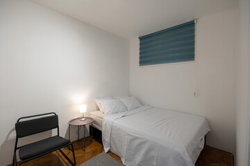 Fototapeta na wymiar Bedroom interior in rental apartment