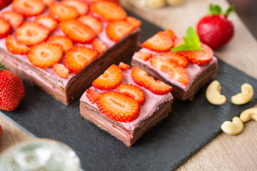No baked raw cake made with dates, cashews and strawberries, close up