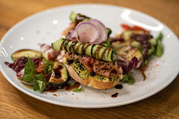 Toasted bread accompanied by serrano ham, tomato, spices and black sesame seeds