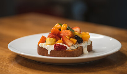 Fresh combination of fruits on brioche bread accompanied by cottage cheese