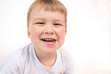 Cute child shows his baby white healthy teeth and open mouth close-up. The concept of oral hygiene, healthy teeth