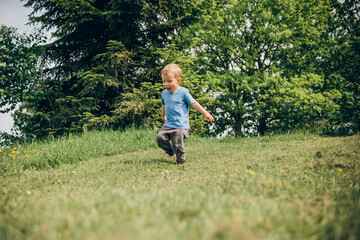 child running on the green lawn
