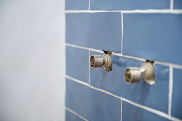 Installation of water tap in bathroom. Installs shower system.