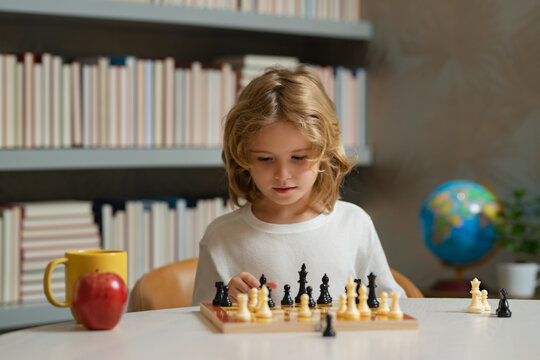 Clever concentrated and thinking child playing chess.