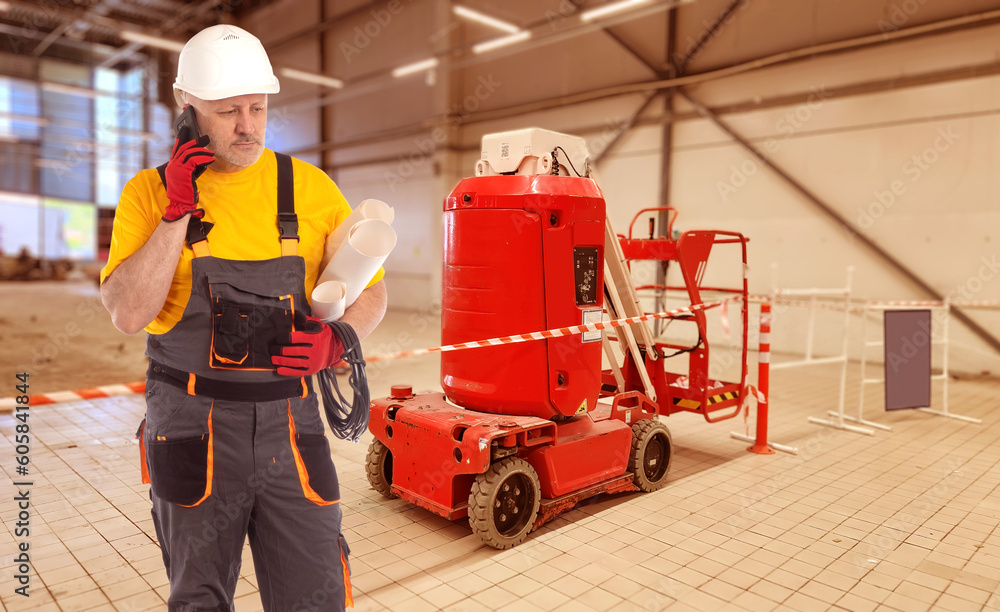 Poster man builder. construction company worker. foreman in building under construction. experienced builde