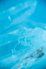Rock crystal in blue light.transparent quartz crystals background in blue tones.texture of gemstone. crystals of natural transparent stone rock.