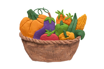 Assorted organic vegetables in wicker basket, handmade with plasticine. Basket with fresh healthy organic vegetables isolated on white background