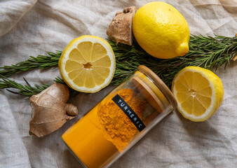 Fresh ginger rosemary and lemon with ground turmeric spice immunity boosters