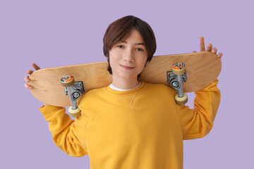 Teenage boy with skateboard on lilac background © Pixel-Shot