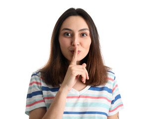 Young woman showing silence gesture on white background, closeup