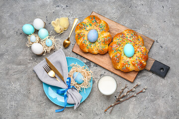 Composition with tasty Italian Easter bread, eggs and glass of milk on grunge background