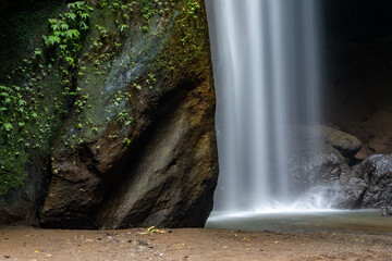 Fototapeta na wymiar Goa Raja Waterfall, Bali, Indonesia Water falling over the Goa Raja Waterfall.