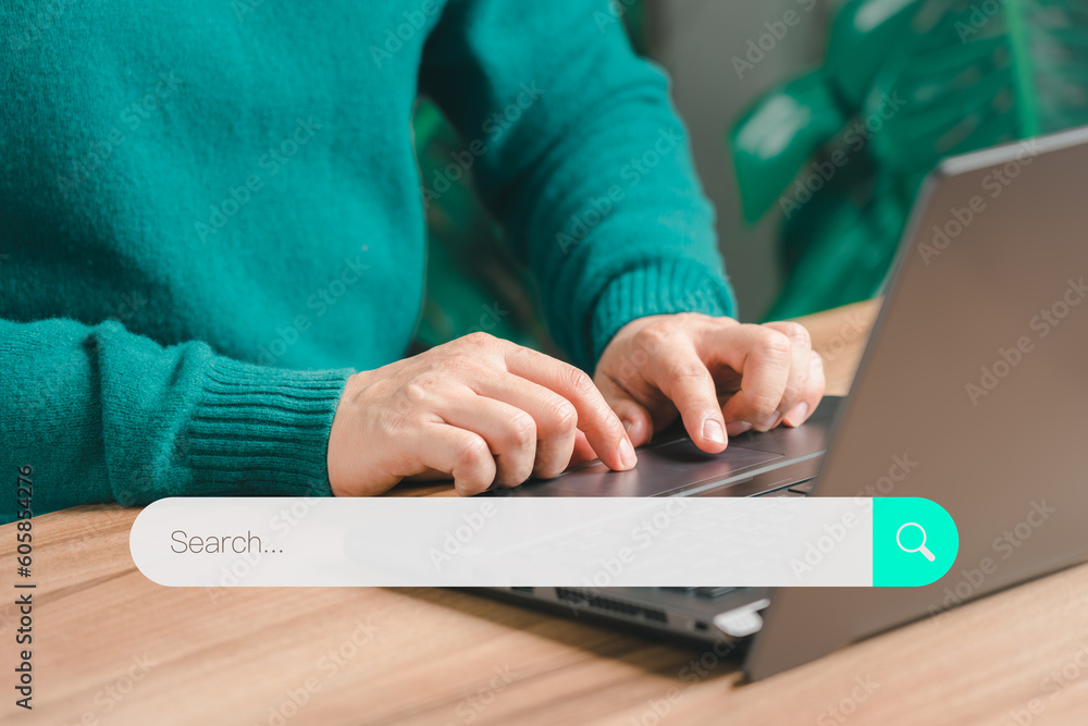 Poster Male hand using laptop computer to search for information. User using the search console with your website. User searching information data on internet networking technology with wifi in home concept.