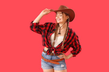 Young cowgirl on red background