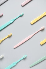 Plastic toothbrushes on grey background