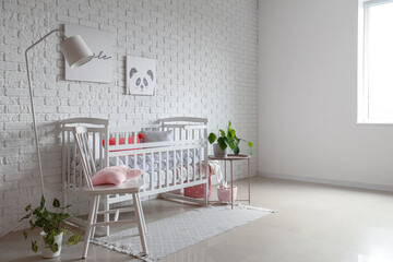Interior of light bedroom with baby crib and chair - obrazy, fototapety, plakaty