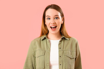 Fototapeta premium Surprised young woman on pink background
