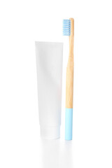 Blue bamboo toothbrush and paste on white background