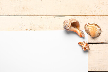 Blank card with seashells and starfish on white wooden background