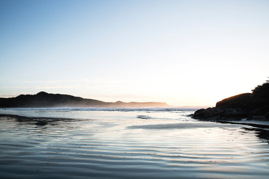 Calm Coastal Pacific Northwest Waters at Sunrise with Distant Hills