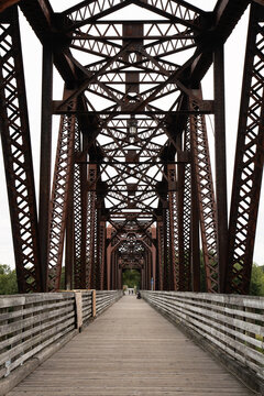 Pedestrian Bridge with Steel Truss Architecture and Symmetrical Perspective