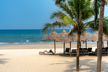 Umbrellas for tourists on the white sand beach at Da Nang city beach, Quang Nam Province, Vietnam