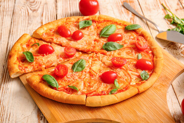 Board with tasty pizza margarita on white wooden background