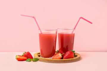 Board with glasses of tasty strawberry juice on white table