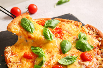Board of tasty pizza margarita with stretching cheese on table, closeup