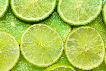Slices of fresh lime as background, closeup