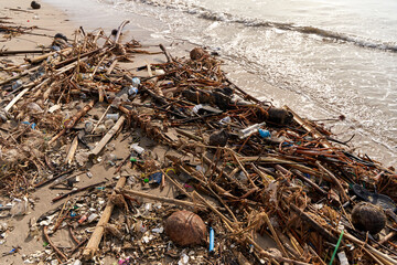 Mountains of waste and garbage on the sandy beach after the tide. Humanity is polluting the ocean
