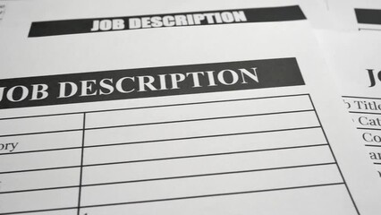 A panning shot of job description forms and paperwork. The concepts of job requirements, responsibilities, work skills, human resources, recruitment and startup business.