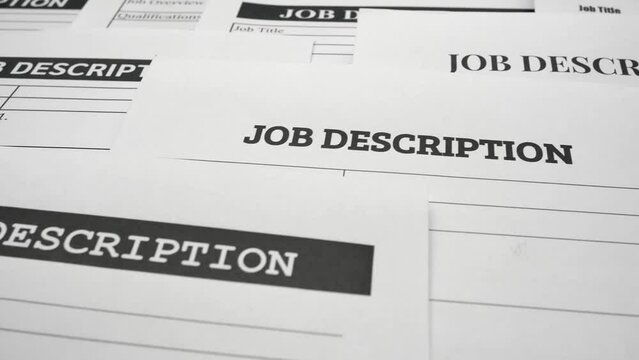 A tracking shot of job description forms and paperwork. The concepts of outsourcing, job requirements, work skills, human resources, recruitment and startup business.