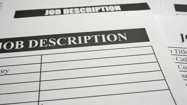 A panning shot of job description forms and paperwork. The concepts of job requirements, responsibilities, work skills, human resources, recruitment and startup business.