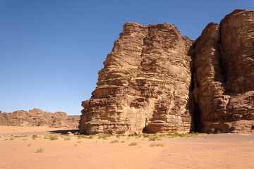 Fototapeta premium Wadi Rum (Valley of the Moon) red sand dunes, sandstone and granite rock view in southern Jordan. Wadi Rum Protected Area was named a UNESCO World Heritage Site in 2011