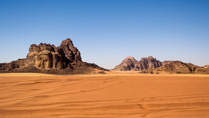 Fototapeta na wymiar Wadi Rum (Valley of the Moon) red sand dunes, sandstone and granite rock view in southern Jordan. Wadi Rum Protected Area was named a UNESCO World Heritage Site in 2011