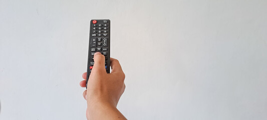 Man's Hand holding television  remote control isolated on white background