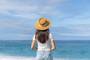 Relaxed woman with straw hat in the beach