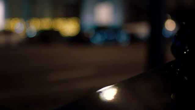 Cars pass on calm street in paris, france during nighttime. Defocus, low angle