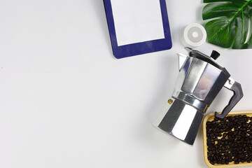 Moka pot coffee beans with product monstera topview