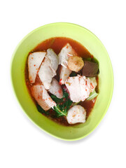 Top view of Yentafo Fish Ball Noodles in a white bowl in green bowl and pink soup, focus selective