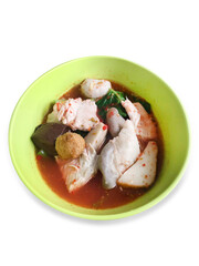 Top view of Yentafo Fish Ball Noodles in a white bowl in green bowl and pink soup, focus selective