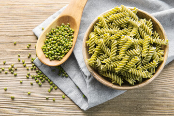 Mung bean fusilli pasta on a old wooden background.