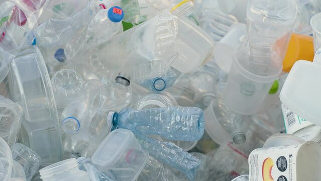 A pile of plastic water bottles, containers and other recyclable items.