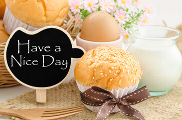 Have a nice day and breakfast, bread bun, milk, egg and blak tag.