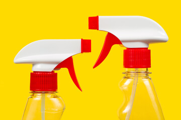 Detergent sprayers on a yellow background. Two sprayers.